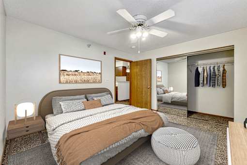 a bedroom with a bed and a ceiling fan at Somerset Apartments, Des Moines, Iowa