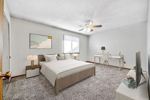 a bedroom with a large bed and a ceiling fan at Somerset Apartments, Des Moines