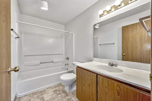 a bathroom with a sink toilet and a bath tub at Somerset Apartments, Des Moines, IA