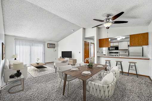 A living room with a dining table and chairs. at Somerset Apartments, Des Moines