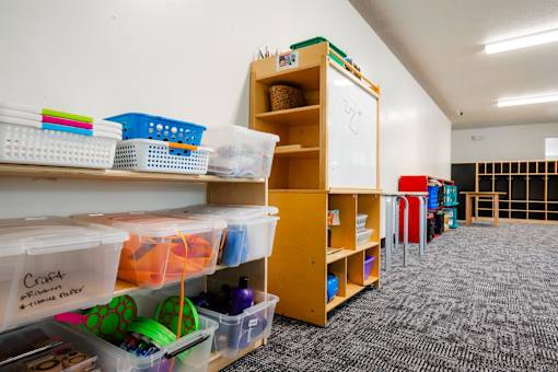 a classroom with shelves and bins and a whiteboard at Sutton Hill Apartments, IOWA, 50320