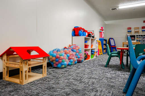 a play room with toys and chairs and a table with chairs at Sutton Hill Apartments, Des Moines, 50320