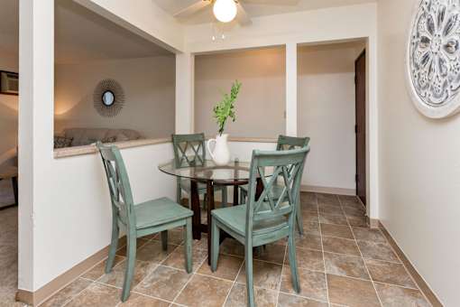 A dining room with a table and chairs at Sutton Hill Apartments, Des Moines, IA