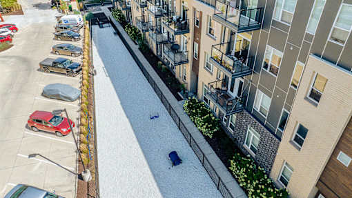 an aerial view of an apartment complex with cars parked in the street at Velocity Apartments, IA, 50309 