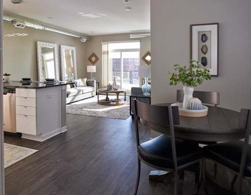 a living room and dining room with a table and chairs at Velocity Apartments, Iowa
