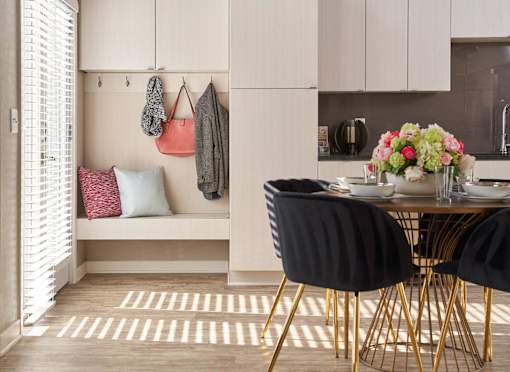 a dining room with a table and chairs at Velocity Apartments, Des Moines, IA