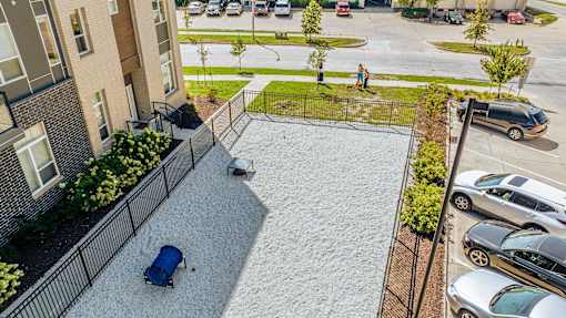 A car is parked on a gravel driveway at Velocity Apartments, Des Moines