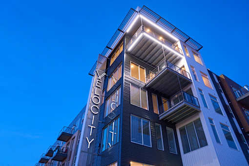 a building with a sign on the side of it at Velocity Apartments, Iowa, 50309