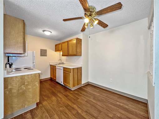 a kitchen with wood floors and a ceiling fan at Foxwood Apartments, Iowa  