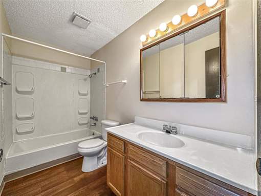 a bathroom with a sink toilet and a mirror at Foxwood Apartments, Indianola, 50125  