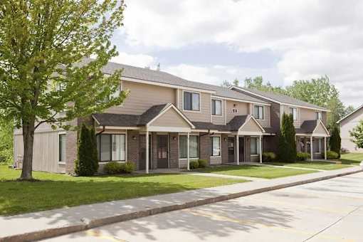 a house with a sidewalk in front of it at Hunters Run Apartments, Newton