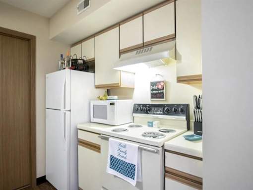 a kitchen with a stove microwave and refrigerator at Hunters Run Apartments, Newton, IA,  50208