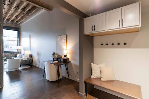 A room with a table, chairs, and a bench.at Plant 1 Lofts, N. Newton, IA 50208  