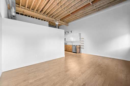 A room with wooden floors and a white wall.at Plant 1 Lofts, Iowa   