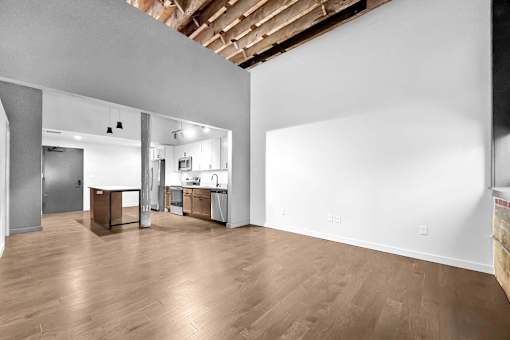 A large empty room with wooden floors and white walls.at Plant 1 Lofts, N. Newton, 50208  