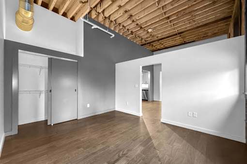 A room with wooden floors and white walls.at Plant 1 Lofts, N. Newton Iowa   