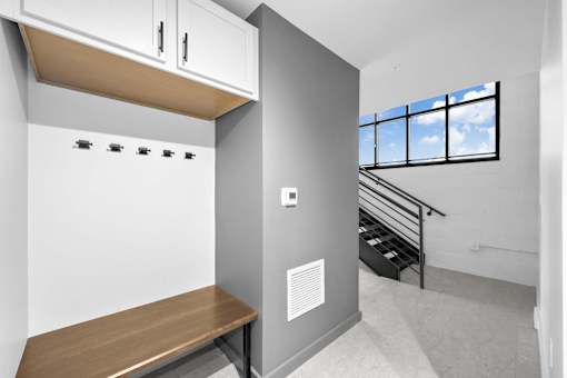 A small room with a bench and a window.at Plant 1 Lofts, Iowa, 50208