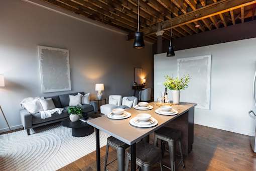 A dining area with a table set for four.at Plant 1 Lofts, N. Newton Iowa   