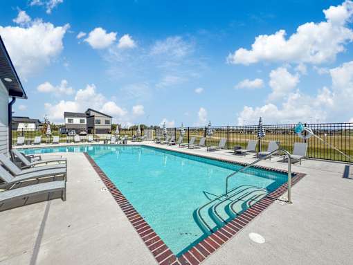our apartments have a resort style pool with lounge chairs at Rialto Townhomes Apartments, Iowa