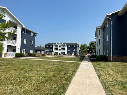 A grassy area in front of apartment buildings.