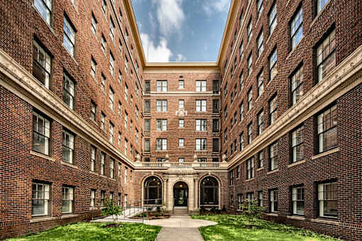 A large brick building with a central arched entrance.