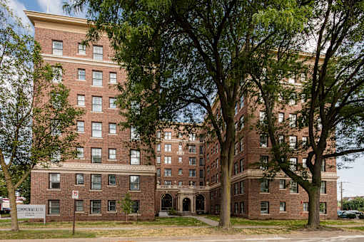 A large brick building with a sign that says "Commonwealth" in front of it.
