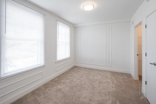 A room with white walls and a carpeted floor.