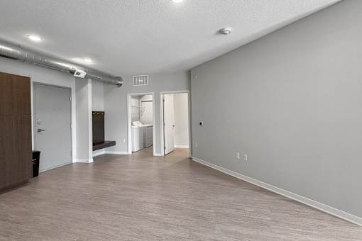A room with a white ceiling and a brown door.