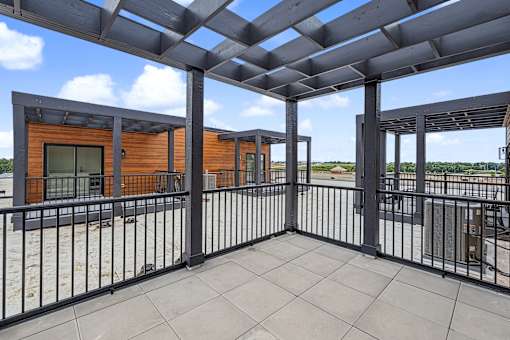 Rooftop terrace with pergola and railing at The Flats at West Glen Apartments, Iowa, 50266