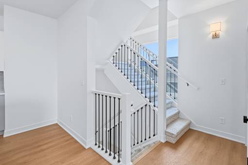 Two story staircase with modern black railings at The Flats at West Glen Apartments, Iowa
