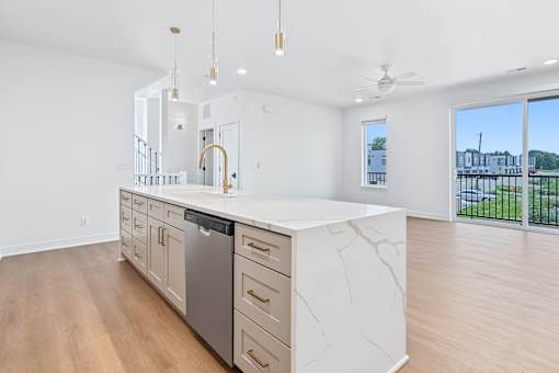Open concept kitchen island with waterfall countertop at The Flats at West Glen Apartments, West Des Moines
