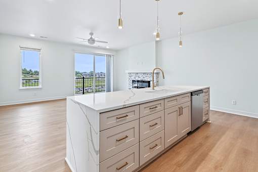 Open kitchen island with white quartz countertop at The Flats at West Glen Apartments, Iowa