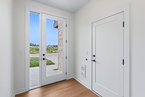 Entryway with glass door and interior access at The Flats at West Glen Apartments, West Des Moines, IA 50266