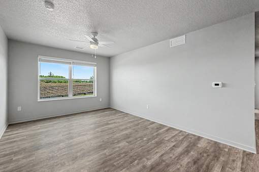 Empty room with a window showing an outdoor view.