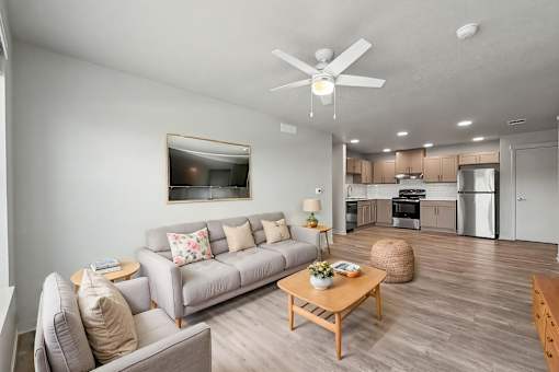 A living room with a grey couch and a coffee table.