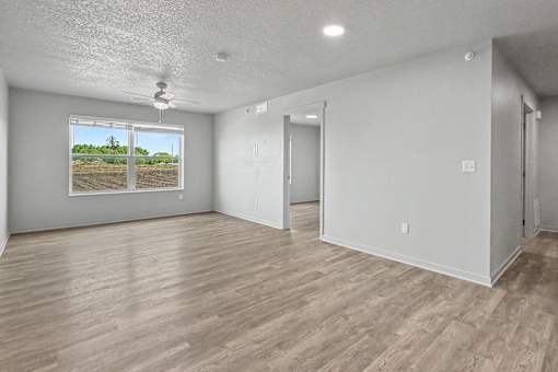 Empty room with a view of a construction site through the window.