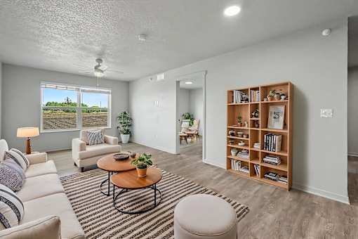 A living room with a sofa, a coffee table, and a bookshelf.