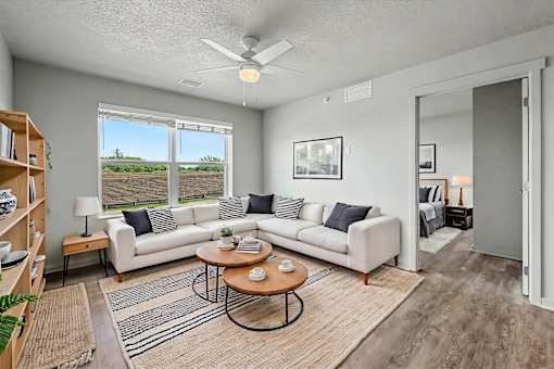 A living room with a white couch and a coffee table.