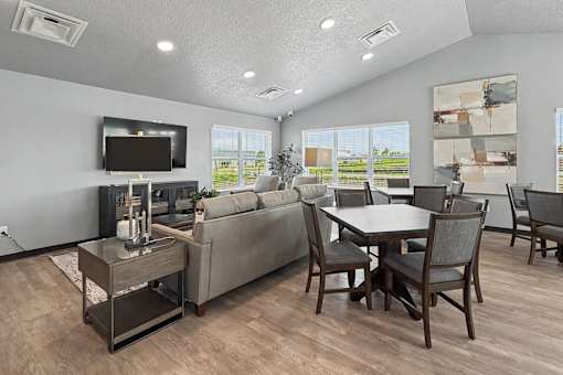A modern living room with a grey couch, a wooden coffee table, and a television.