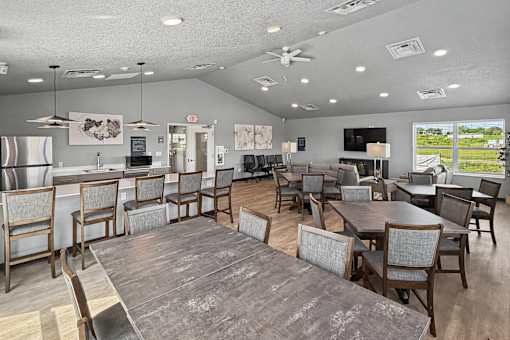A large room with a dining table and chairs.