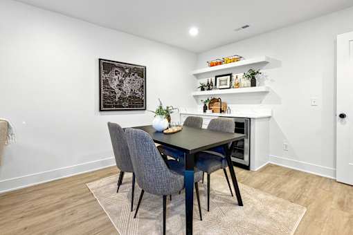 Finished basement with an area for sitting, plus, a wet bar for hosting.