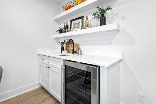 A kitchen with a white oven and white cabinets.
