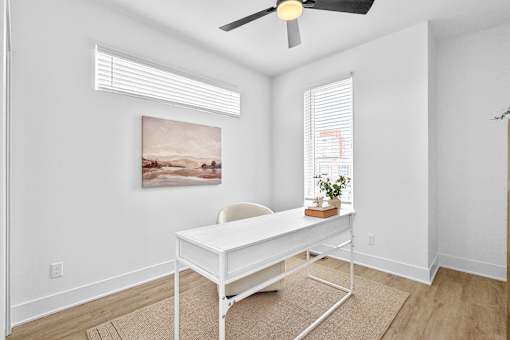 A spacious den that could be used as a home office or home workout space.