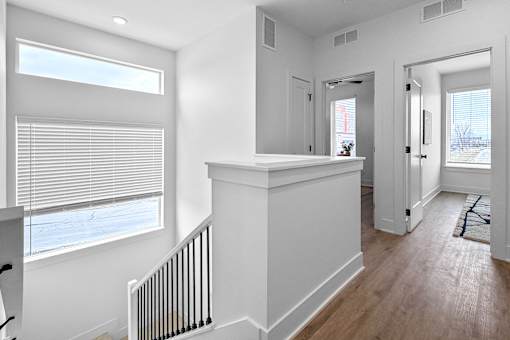 A white interior of a room with a window and a radiator.
