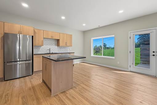 A kitchen with wooden floors and a large island.