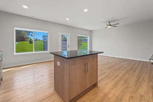 A room with a wooden cabinet and a ceiling fan.