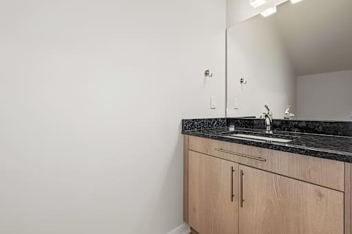 A bathroom with a sink and a mirror.
