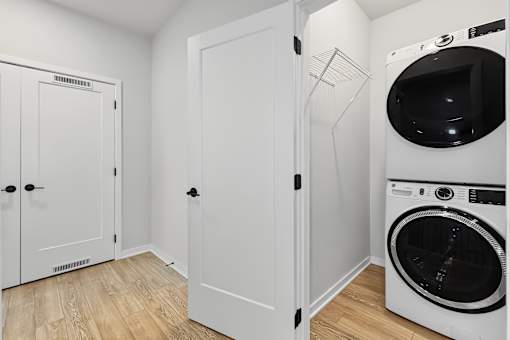 A white laundry room with a washer and dryer.