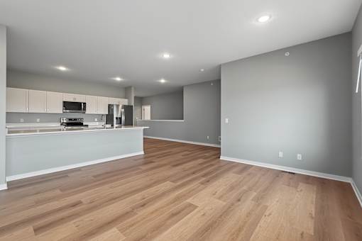 A kitchen with wooden floors and white walls.