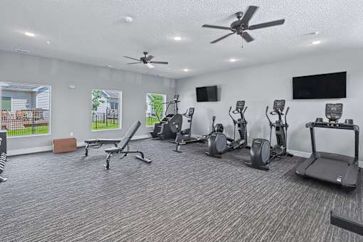 A spacious home gym with a variety of exercise equipment.